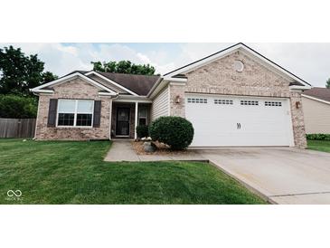 Charming single-story home featuring a brick facade, a two-car garage, and a well-maintained front lawn at 4233 Pearson Dr, Westfield, IN 46062