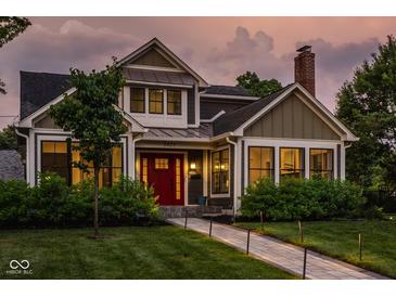 Charming two-story home with a red front door, well-manicured lawn, and inviting walkway at 5425 N Delaware St, Indianapolis, IN 46220