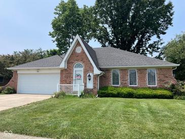 Charming brick single Gathering home featuring a well manicured lawn and attached garage at 806 S Jefferson St, Brownsburg, IN 46112