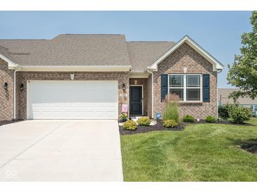 Charming brick home with a well-manicured lawn, featuring a two-car garage and classic architectural details at 8842 Twain Ln, Indianapolis, IN 46239