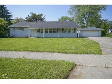 Charming single-story home with a well-manicured lawn and detached two-car garage at 11 Sayre Dr, Greenwood, IN 46143