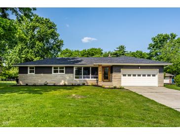 Charming single-story home featuring a well-maintained lawn and stone accents at 130 N High School Rd, Indianapolis, IN 46214