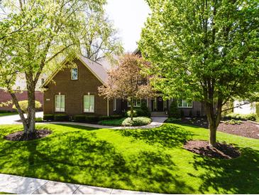 Charming brick home featuring a manicured lawn and mature shade trees at 16307 Stony Ridge Dr, Noblesville, IN 46060