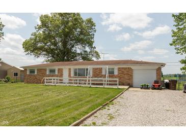 Charming single-story brick home with a well-manicured lawn and attached garage, offers classic curb appeal at 2170 N Old State Road 9, Columbus, IN 47203