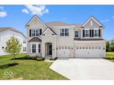 Beautiful two-story home with brick exterior, three-car garage, and well-manicured lawn at 4253 Ironclad Dr, Bargersville, IN 46106