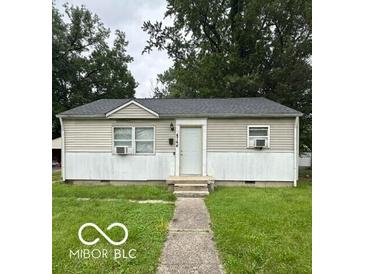 Charming single-story home with neutral siding, manicured lawn, and inviting front entrance at 4744 E 33Rd St, Indianapolis, IN 46218