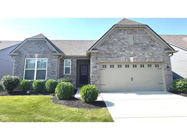 Charming gray brick home with a two-car garage, well-manicured lawn, and beautiful landscaping at 5103 Covington Ave, McCordsville, IN 46055