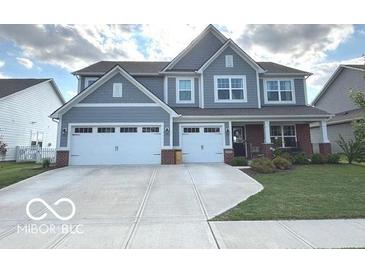 Charming two-story home with a two-car garage, covered porch, and manicured lawn at 520 Ferndale Ln, Danville, IN 46122