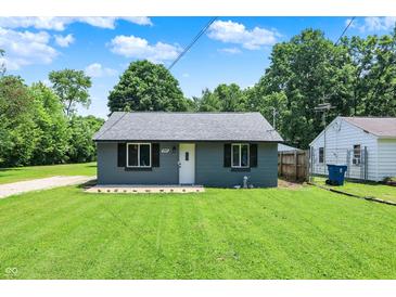 Charming single-story home showcasing a well-maintained lawn and neutral exterior paint at 6949 Crittenden Ave, Indianapolis, IN 46220