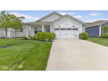Charming single-story home featuring a well-manicured lawn and a two-car garage with white exterior at 820 Elise Dr, Westfield, IN 46074