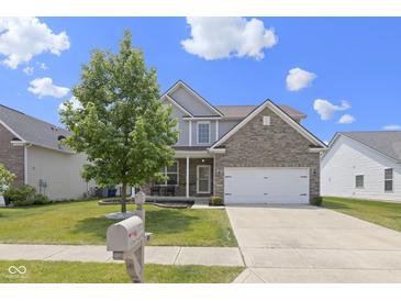 Charming two-story home with a brick and siding exterior, manicured lawn, and inviting front porch, creating curb appeal at 8720 N Deer Crossing Blvd, McCordsville, IN 46055