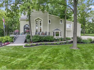 Charming two-story home with landscaped yard and a beautiful porch, perfect for relaxing outdoors at 17320 Joliet Rd, Westfield, IN 46074
