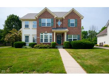 Charming two-story brick home featuring a well-manicured lawn and inviting walkway at 17877 Kinder Oak Dr, Noblesville, IN 46062