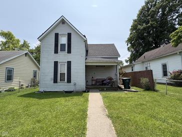 Charming two-story home with black shutters and a well-maintained front lawn at 1809 E 13Th St, Muncie, IN 47302