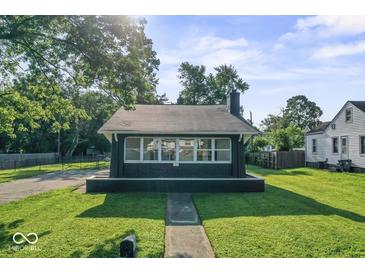 Charming home featuring a well-maintained lawn, covered front porch, and classic architectural details at 2719 Denison St, Indianapolis, IN 46241