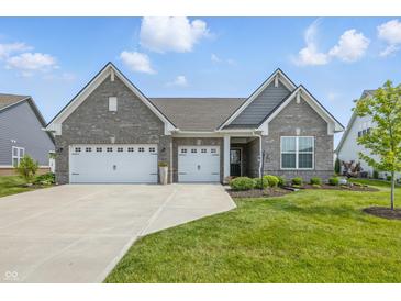 Beautiful single Gathering home featuring an attached three car garage and manicured lawn at 3839 Albert Ln, Bargersville, IN 46106