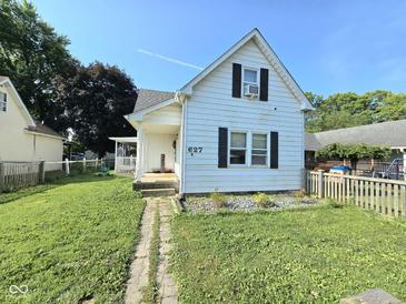 Charming white home with a well-manicured lawn and inviting front porch at 627 Plum St, Noblesville, IN 46060