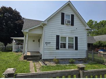 Charming two-story home featuring a cozy porch and classic shutters at 627 Plum St, Noblesville, IN 46060