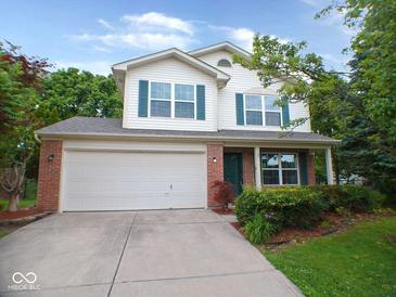 Charming two-story home with a brick facade, vinyl siding and a two-car garage at 6412 Cradle River Dr, Indianapolis, IN 46221
