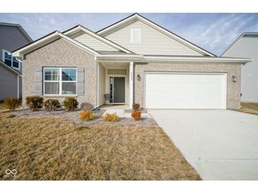 Charming single-Gathering home featuring a two-car garage and well-maintained front yard at 6608 W Shoreline Ct, Greenfield, IN 46140