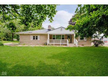 Charming single-story home featuring a large, well-maintained front lawn and inviting front porch at 91 N Raceway Rd, Indianapolis, IN 46234