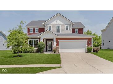 Charming two-story home with landscaped yard and a welcoming entrance, plus a two car garage at 11840 Crossbill Ct, Noblesville, IN 46060