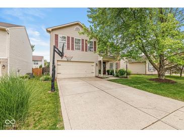 Charming two-story home featuring a spacious driveway, two-car garage, and well-manicured lawn at 12259 Sweet Creek Trl, Fishers, IN 46037