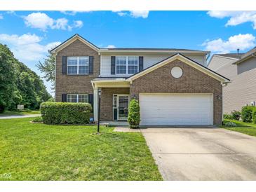 Charming two-story home with a brick and vinyl exterior, a well-manicured lawn, and an attached two-car garage at 12322 Cool Winds W Way, Fishers, IN 46037