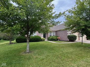 Charming brick home with mature trees and lush landscaping at 13744 Fieldshire Ter, Carmel, IN 46074