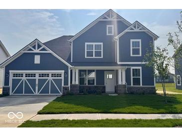 Charming two-story home features a blue exterior, well-manicured lawn, and an attached two-car garage at 18955 Seaforth Way, Westfield, IN 46074