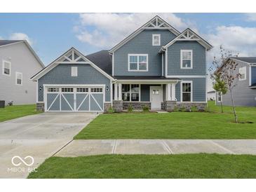 Beautiful two-story home featuring a well-manicured lawn, neutral colors, and a two-car garage at 18955 Seaforth Way, Westfield, IN 46074