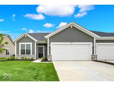 Charming gray home with a well-manicured lawn and a two-car garage, all under a beautiful blue sky at 2021 Frost Line Ln, Greenfield, IN 93927