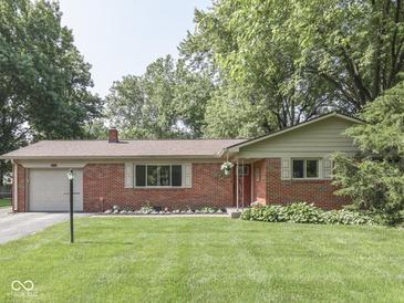 Charming single-story brick home with a well-manicured lawn and inviting curb appeal at 343 E Waterbury Rd, Indianapolis, IN 46227