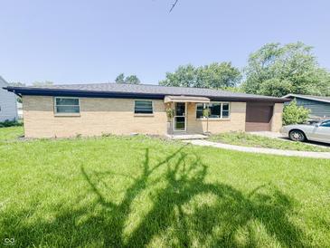 Charming brick ranch-style home featuring a well-maintained lawn and mature trees at 3613 N Locust St, Muncie, IN 47304