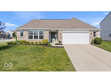 Charming brick home with a well-manicured lawn and attached two car garage at 4420 Wild Turkey Dr, Indianapolis, IN 46239