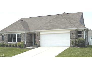 Charming brick home featuring a two-car garage and a well-maintained lawn, offering great curb appeal at 4420 Wild Turkey Dr, Indianapolis, IN 46239