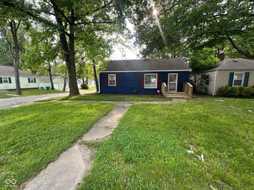 Charming single-story home with a well-maintained lawn and inviting front porch at 5704 N Keystone Ave, Indianapolis, IN 46220