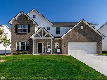 Charming two-story home with brick and siding, well-manicured lawn, and a two-car garage at 628 Tess Blvd, Westfield, IN 46074