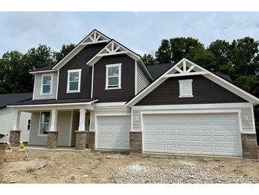 Two-story home featuring a two-car garage and stylish architectural detailing at 8356 Leander Ave, Zionsville, IN 46077