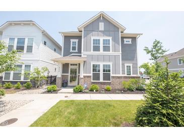 Charming two-story home with manicured front yard, lush green lawn, and inviting walkway at 9248 Hawley Dr, Indianapolis, IN 46216