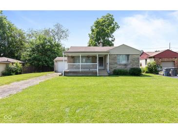 Charming single-story home with a well-manicured lawn and a quaint front porch at 1020 N Ritter Ave, Indianapolis, IN 46219