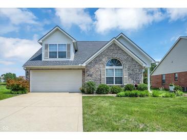 Charming single-Gathering home featuring a brick facade, attached garage, and well-manicured lawn at 10712 Cardinal Cir, Indianapolis, IN 46231