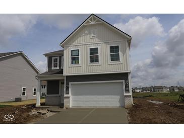 Charming two-story home with gray and white siding and a two-car garage on a sunny day at 1890 Victor Higgins Dr, Shelbyville, IN 46176