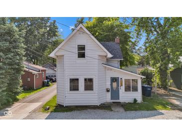 Charming two-story home featuring a tidy front yard, classic architectural details, and a welcoming blue front door at 247 N 14Th St, Noblesville, IN 46060