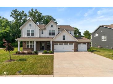 Charming two-story home boasts a three-car garage, brick accents, and a well-manicured lawn at 4642 Boyd Pl, Westfield, IN 46062