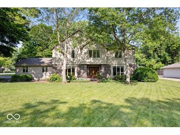 Charming two-story home with brick accents, large front yard, and mature trees at 54 Horseshoe Ln, Carmel, IN 46033