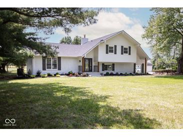 Charming two-story home with painted brick, dark shutters, and a lush green lawn at 5707 In-234, McCordsville, IN 46055