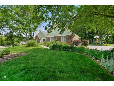 Charming home with a well-maintained lawn and lush landscaping at 6118 Deerwood Dr, Greenwood, IN 46143