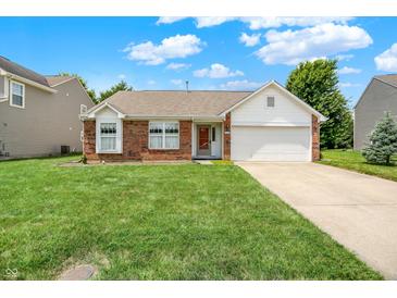 Charming single Gathering home with brick facade, two-car garage and well-manicured lawn on a sunny day at 8038 Sydney Ln, Avon, IN 46123