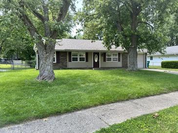 Charming single story home with well-manicured lawn and beautiful mature trees at 1108 Pierce Dr, Plainfield, IN 46168